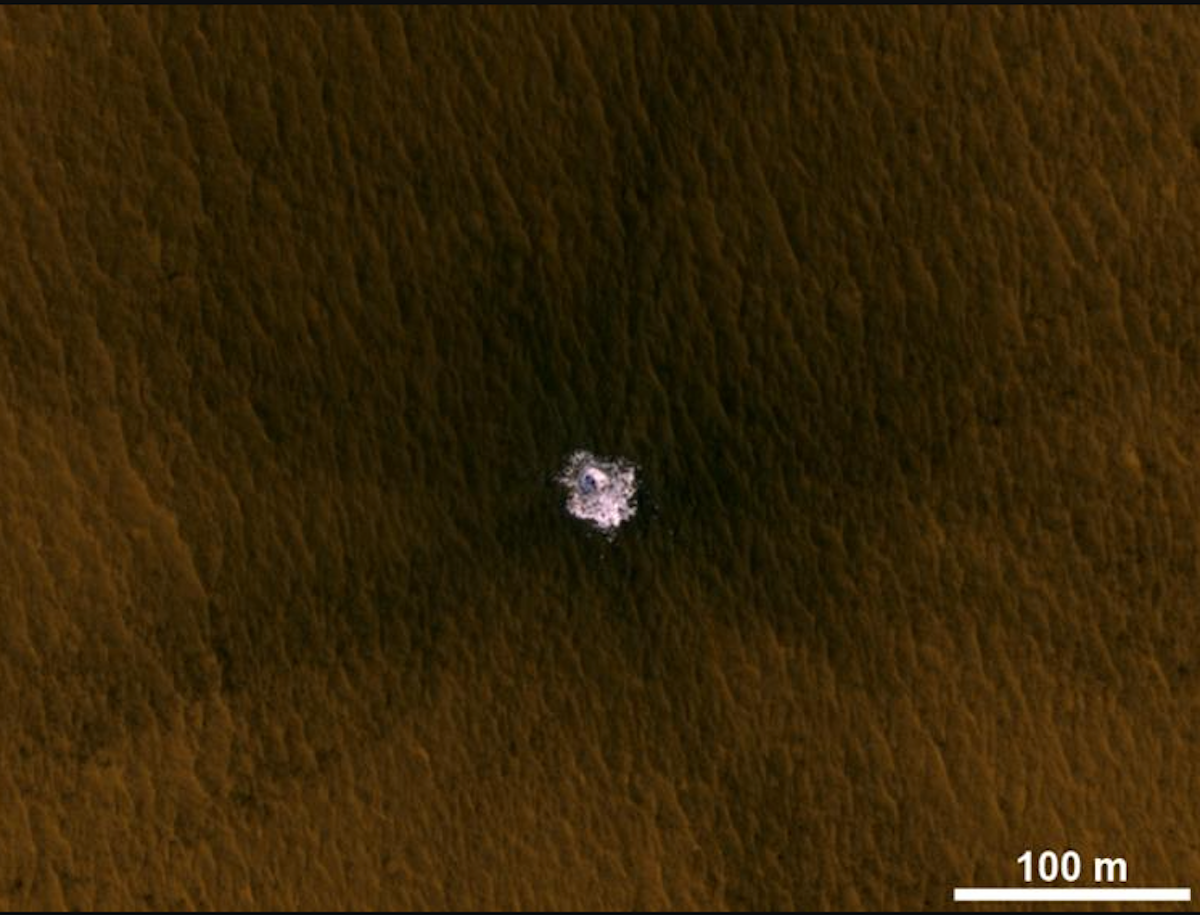 an image of the surface of Mars with a bit of ice exposed