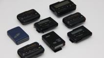 A curated collection of eight vintage pagers from various brands and models is meticulously arranged on a pristine white background.