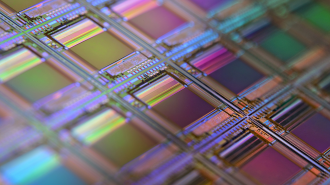 Close-up of a colorful microchip with intricate circuit patterns in a grid formation, reflecting light, capturing the essence of the technology supercycle.