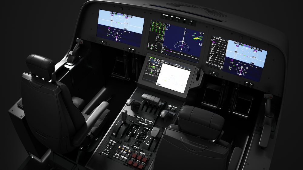 The cockpit interior of the aircraft, designed for supersonic flight, features multiple digital display screens and various control panels, all arranged meticulously before the two seats.